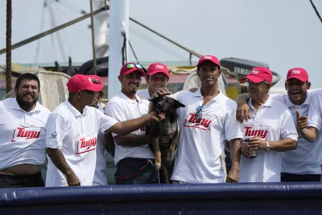 The crew of the Mexican tuna boat Maria Delia with Bella, the dog of Australian Timothy Lyndsay Shaddock