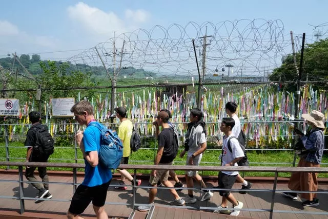 Visitors pass a wire fence in Paju, South Korea, near the border with North Korea 