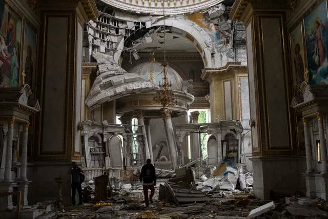Church personnel inspect damage inside the Odesa Transfiguration Cathedral