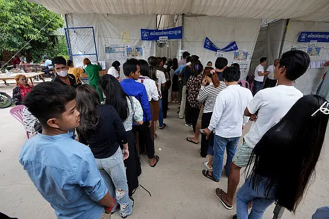 People wait to vote at a polling station