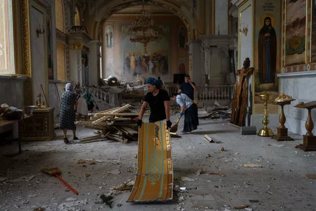 People clean up inside the Odesa Transfiguration Cathedral