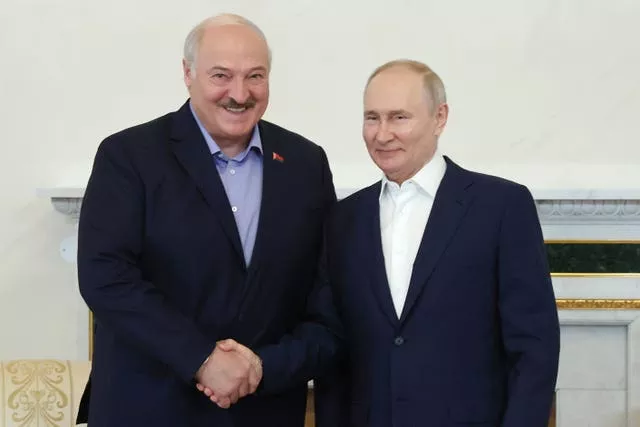 Alexander Lukashenko and Vladimir Putin shake hands