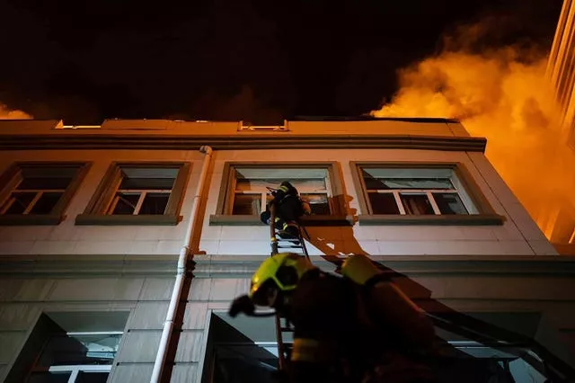 Firefighters work to extinguish a fire after a Russian attack in Odesa