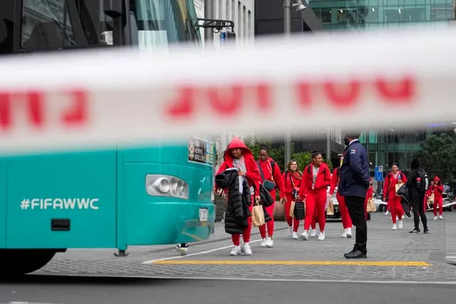 Members of the Philippines Women’s World Cup squad walk to their team bus after a shooting near their hotel in the central business district in Auckland
