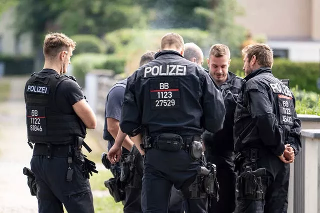 Police officers co-ordinate the search for a wild animal in a residential area in Teltow, Germany