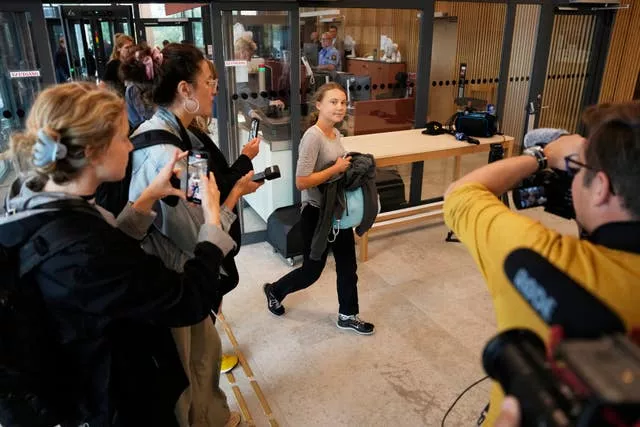 Climate activist Greta Thunberg of Sweden, centre, enters a court before a hearing in Malmo, Sweden