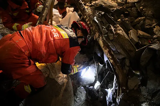 Rescuers search for trapped victims