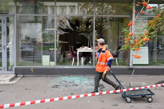 A man walks past a damaged building after a reported drone attack in Moscow