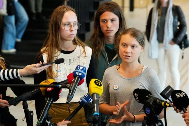 Climate activists Greta Thunberg, right, Elvin Landaeus Csizmadia, centre, and Irma Kjellstrom, speak to the media after a hearing in a court in Malmo, Sweden 