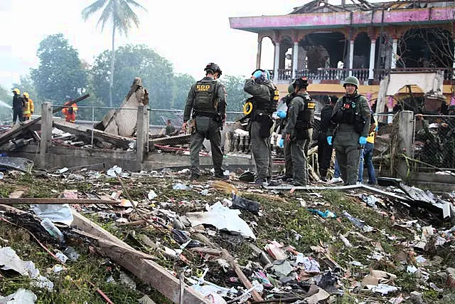 A Thai bomb squad examines the site of an explosion at a firework warehouse in Narathiwat province, southern Thailand