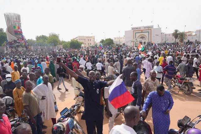 Protesters, some holding Russian flags, in the capital of Niger