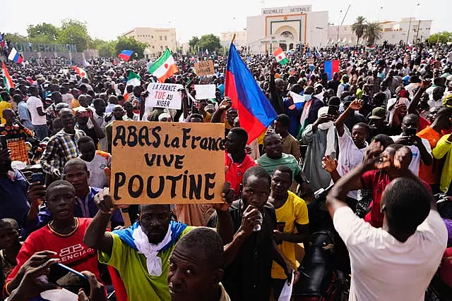 Nigeriens participate in a march called by supporters of coup leader General Abdourahmane Tchiani in Niamey, Niger