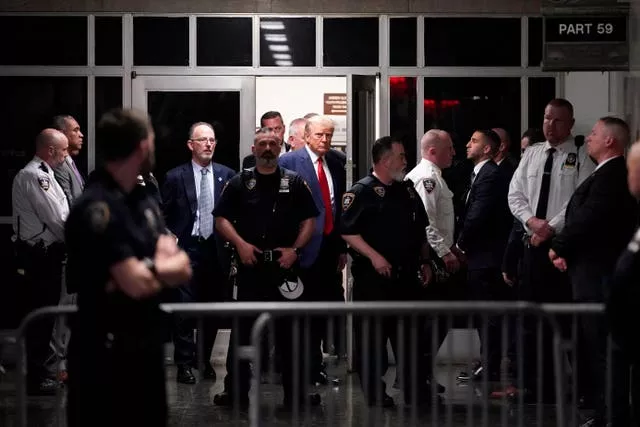 Donald Trump is escorted to a courtroom on April 4, 2023, in New York