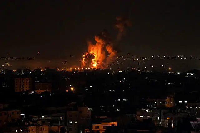 Fire and smoke rise following an Israeli air strike in the central Gaza Strip