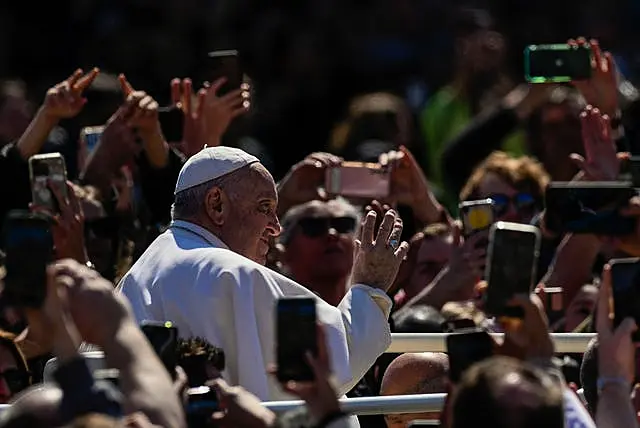 Pope Francis waves from his popemobile to the faithful gathered in St Peter’s Square at the Vatican at the end of the Easter Sunday Mass