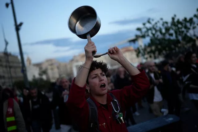 A person bangs pots and pans in Marseille, southern France