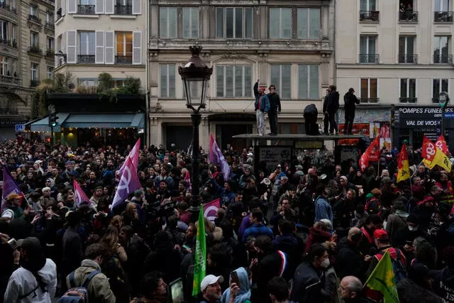 People demonstrate in Paris after French President Emmanuel Macron sought to defuse tensions in a televised address to the nation