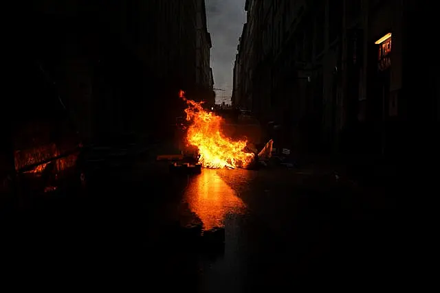 A barricade burns during a protest in Lyon, central France, on Friday