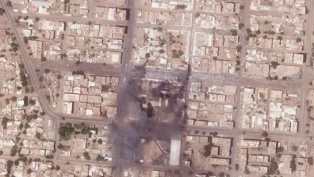 This satellite photo from Planet Labs PBC shows fires and destroyed market stalls in a commercial area of northern Khartoum, Sudan 