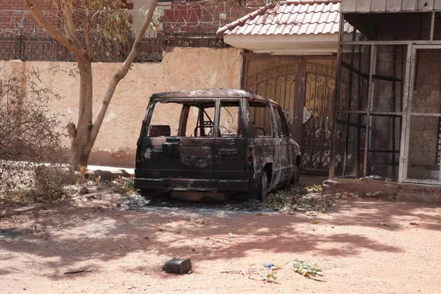 A destroyed vehicle in southern Khartoum, Sudan