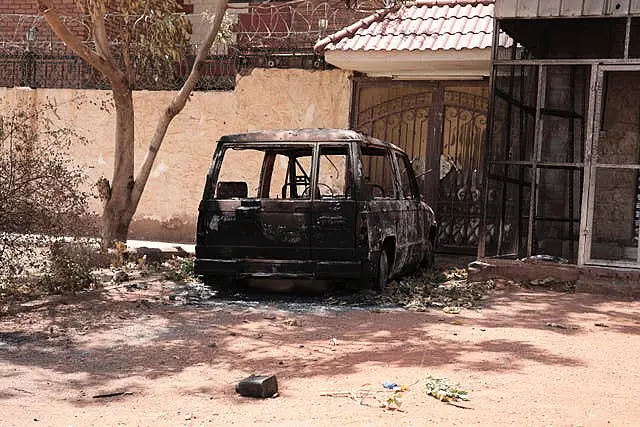 A destroyed vehicle in southern Khartoum, Sudan