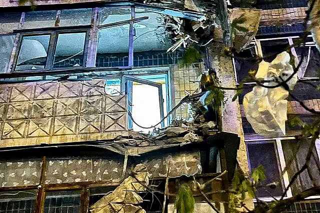 Damaged apartment building near the crater after an explosion in Belgorod, Russia