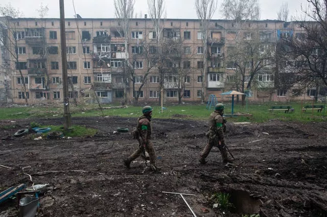 Ukrainian soldiers walk in an area of the heaviest battles in Bakhmut in Donetsk region, Ukraine