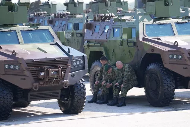 Serbian soldiers rest during a military exercise 