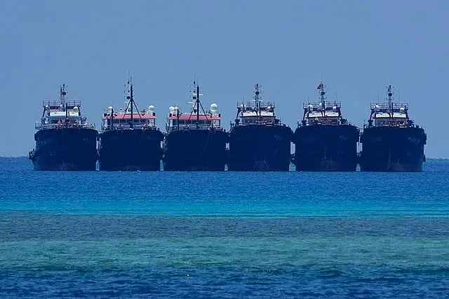 Some of the many suspected Chinese militia ships lay side by side at the Philippine-claimed reef called Whitsun