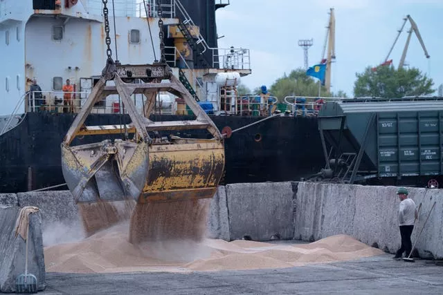 Workers load grain at a grain port in Izmail, Ukraine