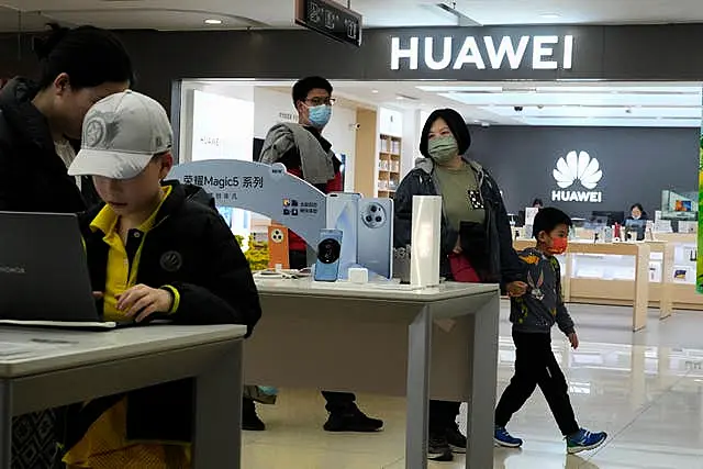 People visit a Huawei shop in Beijing