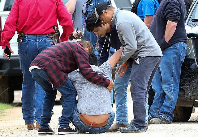 Texas Mass Shooting - A loved one is consoled by others as he arrives at the scene where five people were shot and killed on Friday night 