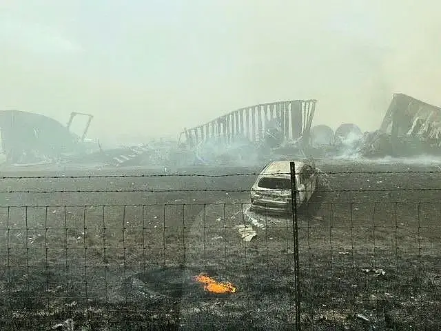 Smouldering wreckage is seen after a crash involving vehicles on a motorway in Illinois