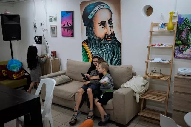 An Israeli family sit in a bomb shelter at an apartment building in the southern city of Ashdod 