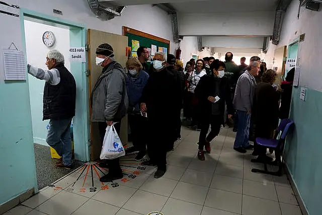 People queue to vote at a polling station in Ankara 