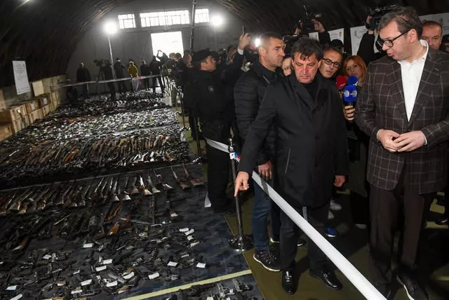 Serbian president Aleksandar Vucic, right, inspects weapons collected as part of an amnesty near the city of Smederevo 