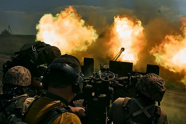 Ukrainian soldiers fire a cannon near Bakhmut, an eastern city where fierce battles against Russian forces have been taking place, in the Donetsk region