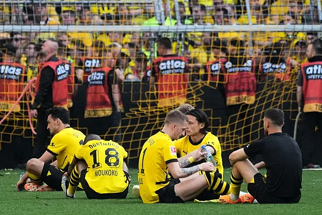 Dortmund’s players sit on the pitch after missing out on the title 