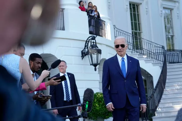 President Joe Biden talks with reporters on the South Lawn of the White House in Washington, Friday, May 26, 2023, as he heads to Camp David for the weekend