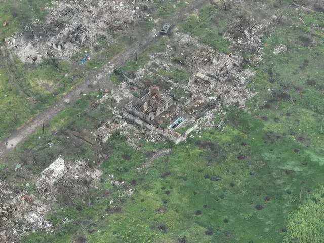 An aerial view of damaged private houses, shell and rocket craters in the suburbs of Donetsk