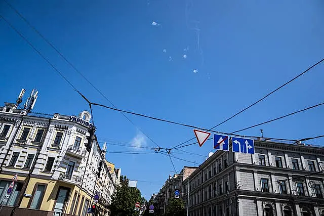 Tracks and white smoke are seen in the sky during Russian rocket attack in Kyiv