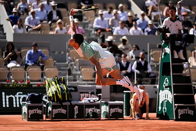 Carlos Alcaraz leaps for a shot against Taro Daniel