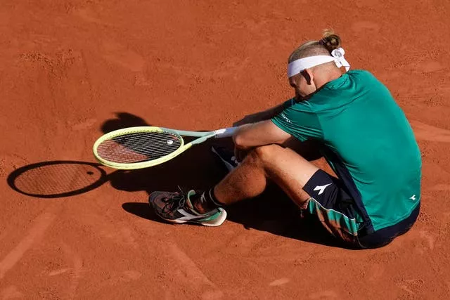 Alejandro Davidovich Fokina sits on the court after slipping 