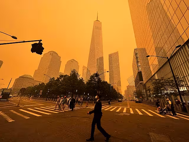 Pedestrians pass the One World Trade Centre in New York City on Wednesday