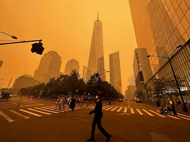 Pedestrians pass the One World Trade Centre in New York City on Wednesday