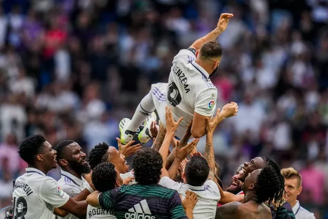 Karim Benzema is thrown in the air by his Real Madrid team-mates 