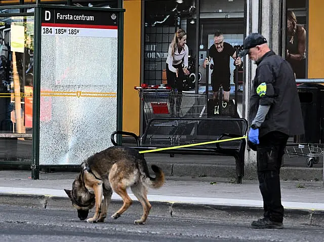 Police at the scene after a shooting incident, in Farsta, southern Stockholm, in June 2023