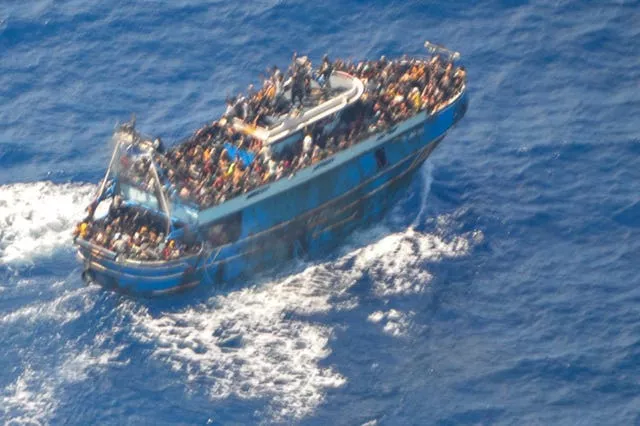 This undated handout image provided by Greece’s coast guard on Wednesday shows scores of people on a battered fishing boat that later capsized and sank off southern Greece