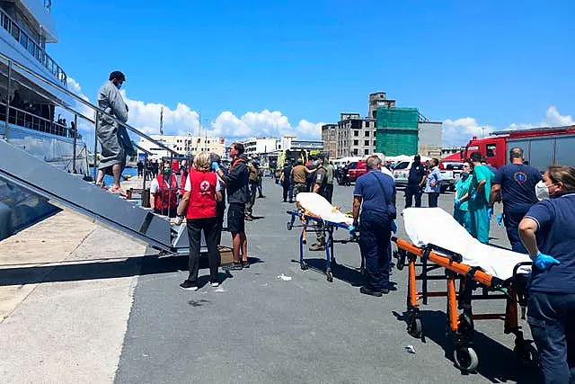 Survivors arrive by yacht at the port in Kalamata town 