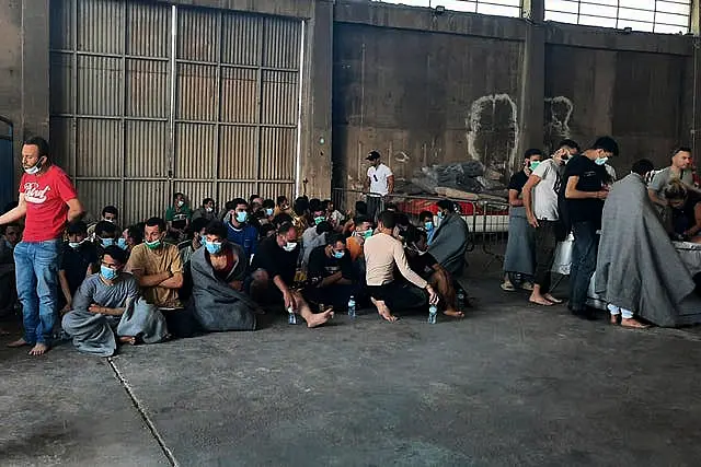 Survivors of a shipwreck at a warehouse at the port in Kalamata town 